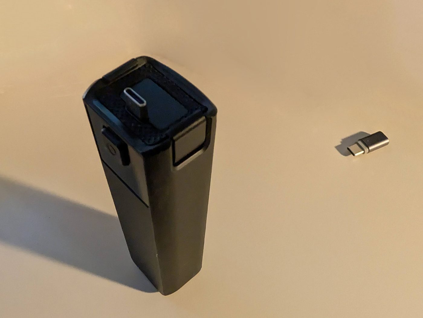 The finished printed adapter standing next to the USB-C extender that fits inside it