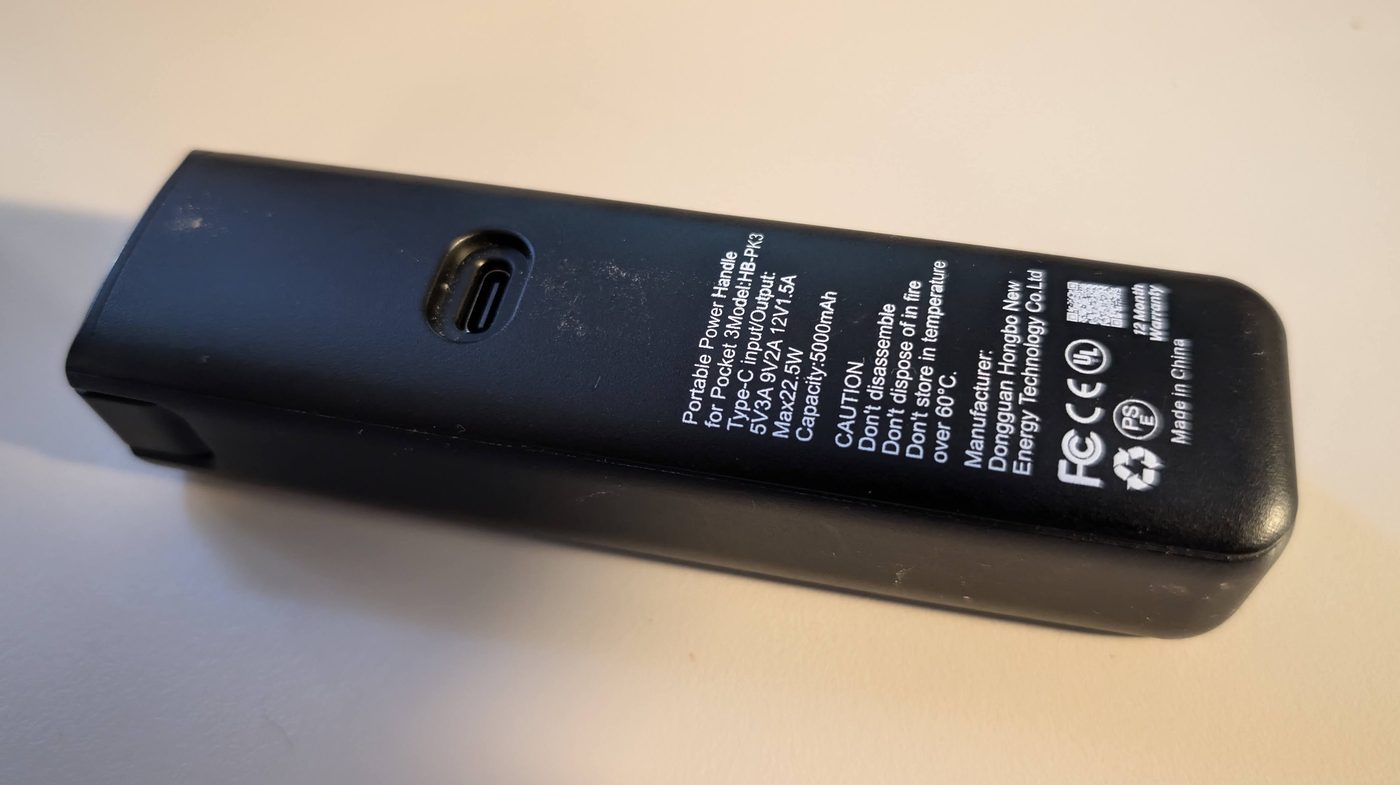 The DJI Osmo Pocket 3 battery handle lying on a table